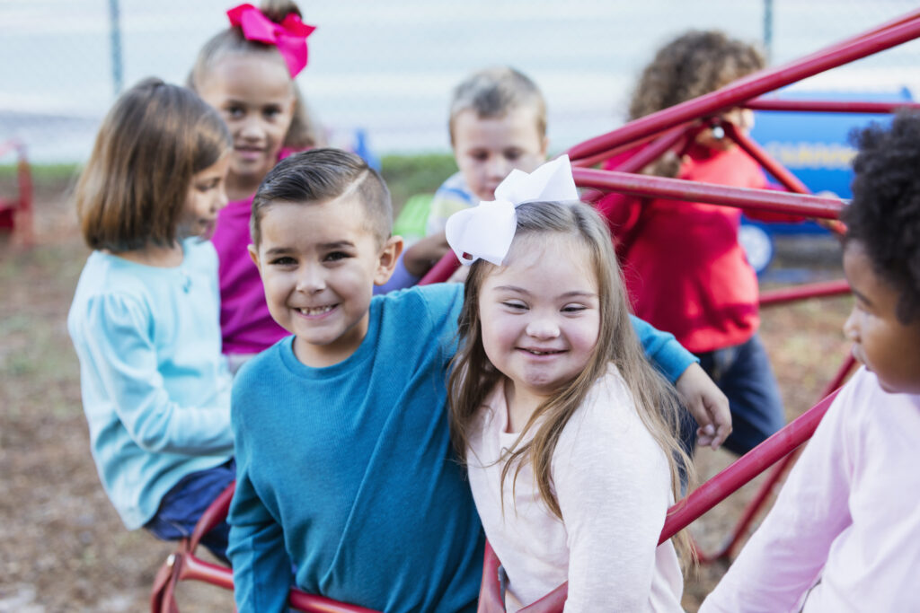 group of children pose together on a school playground