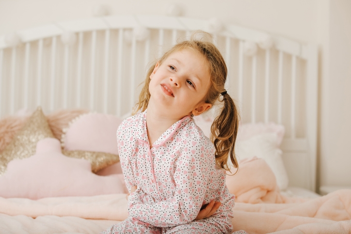 Young girl holds stomach symbolizing a tummy ache