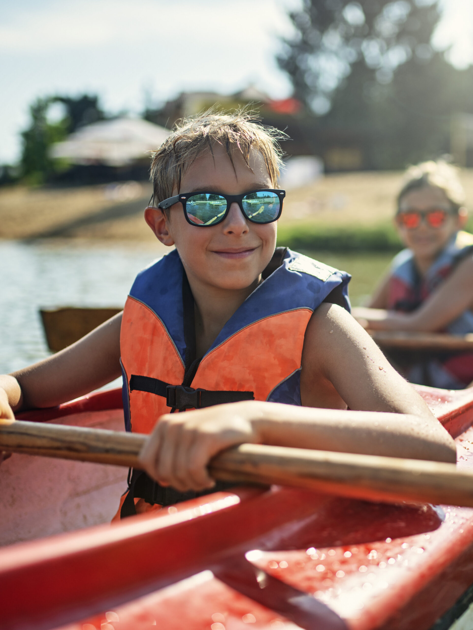 Boys enjoy kayaking at summer camp