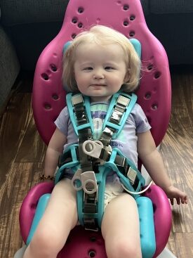 Everleigh smiles in her car seat