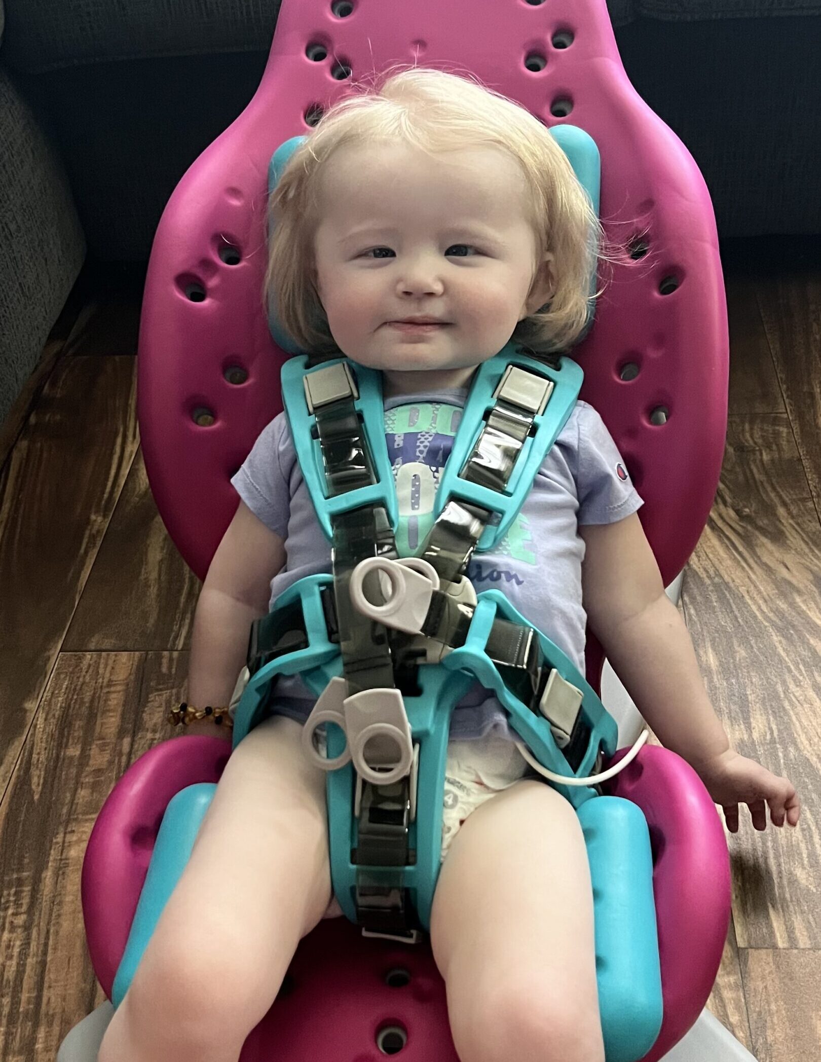 Everleigh smiles in her car seat