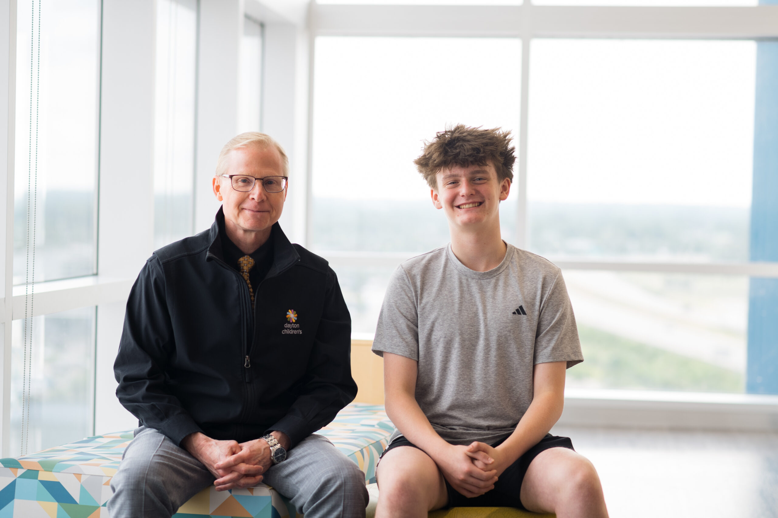Nehemiah and Dr. Evans smile for a photo