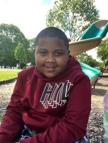 Jamal smiles for the camera while on the playground